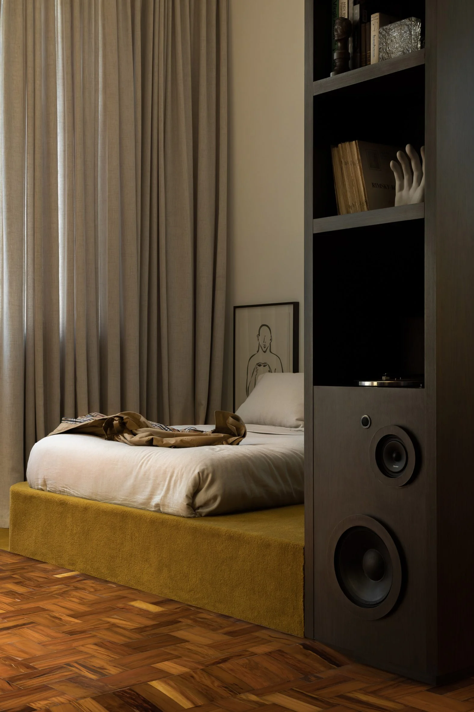 Walnut built-ins divide a living area from the sleeping quarters